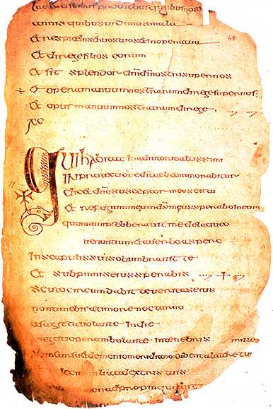 A worn vellum page of the late-sixth-century Cathach psalter, written in Insular majuscule script, with an enlarged decorated initial beginning a psalm.
